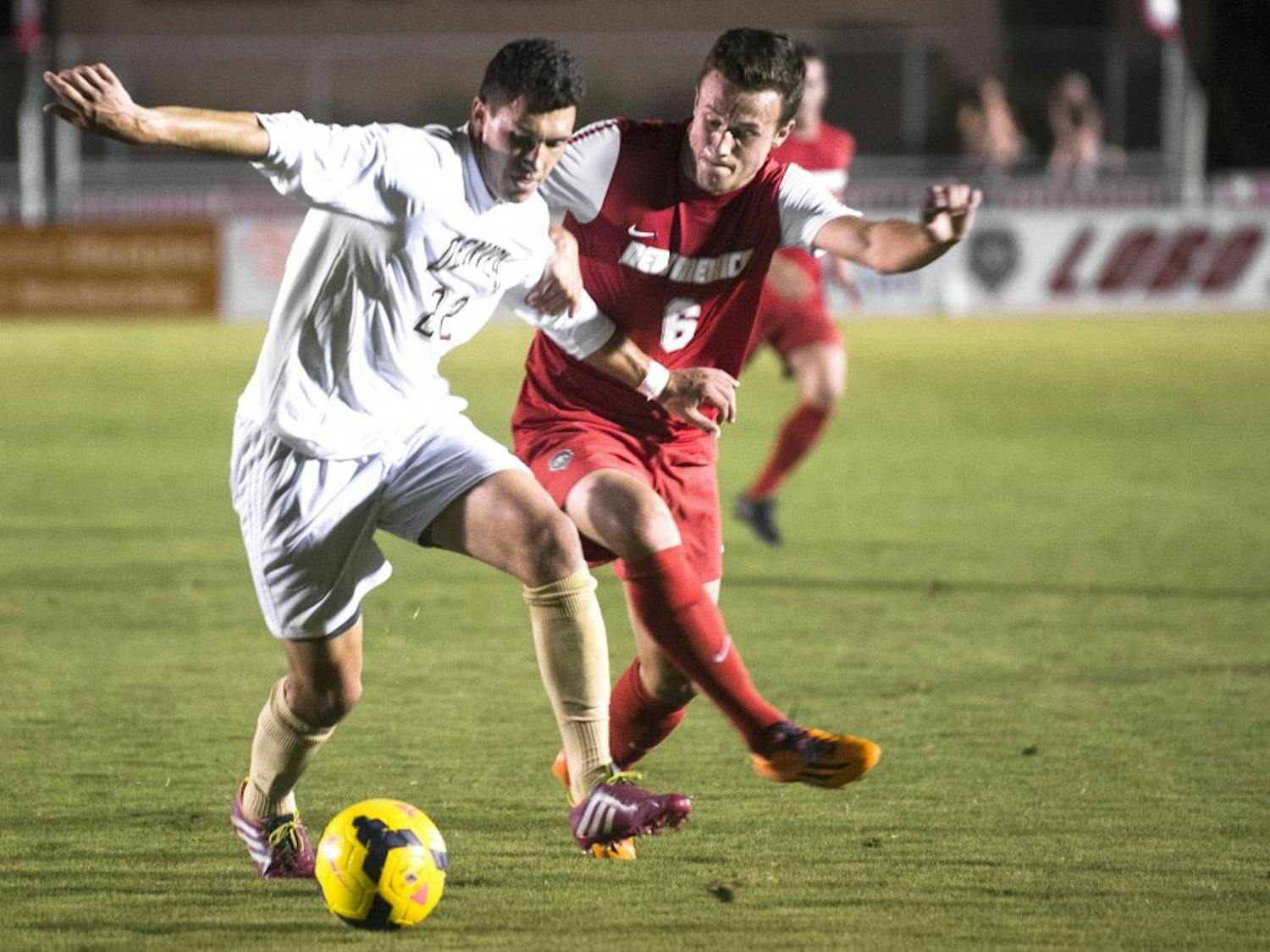 New Mexico men’s soccer midfielder Ben McKendry, right, battles for possession against Denver’s Jordan Schweitzer on Saturday. The Lobos play Akron at the UNM Soccer Complex today at 7 p.m.