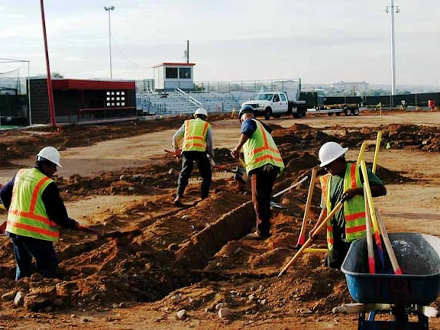Construction crews work at the UNM Softball Complex on Tuesday. The $1 million project will include new dirt and grass, a rain-resistant warning track, new lighting and extra seating.