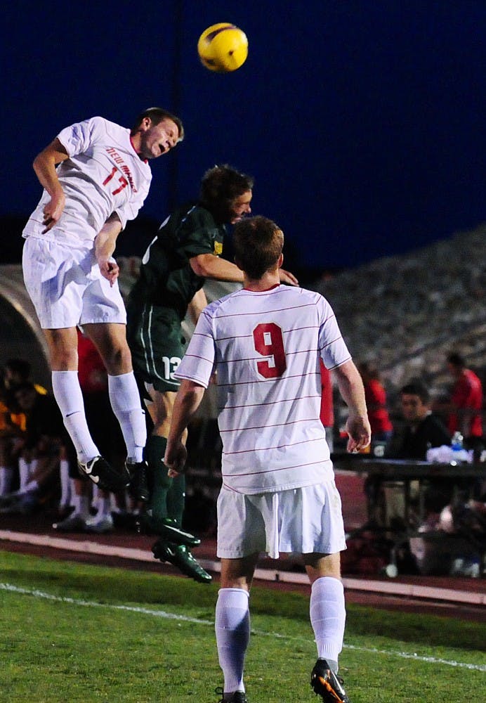 	Lance Rozeboom leaps over a San Francisco defender during Saturday’s 1-0 loss to the Dons. The Lobos had several opportunities to score, but didn’t take advantage of them.