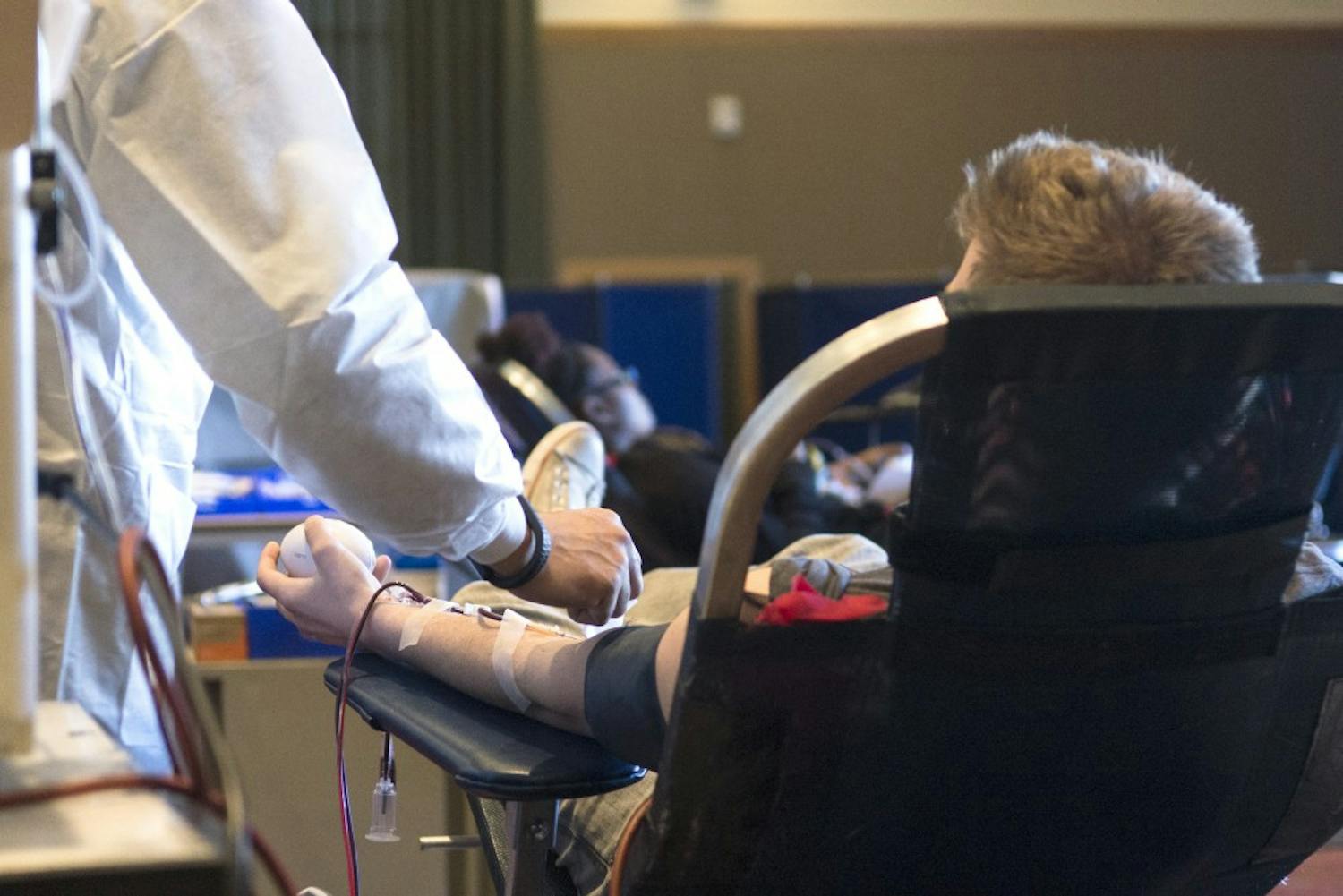 Ben Studer, a senior in Family Studies, donates blood for the Battle I-25 Blood Drive vs NMSU at the SUB Ballroom on Monday. The blood drive event is in its second year and runs through this week inside the SUB and at bloodmobiles around campus. 