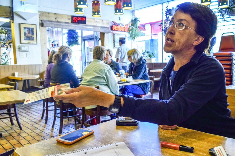 Gloria&nbsp;LaRiva hands a campaign leaflet to Jorge Limas, who told LaRiva he had two felonies and wasn't able to vote. LaRiva is running under the Socialist Party for the 2016 presidential election.&nbsp;