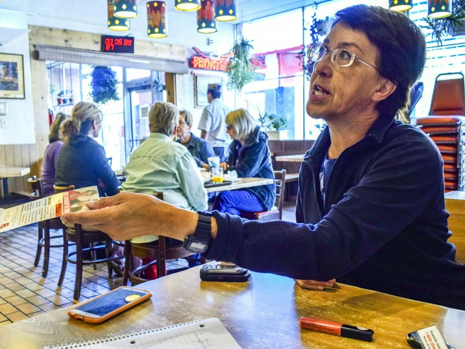 Gloria LaRiva hands a campaign leaflet to Jorge Limas, who told LaRiva he had two felonies and wasn't able to vote. LaRiva is running under the Socialist Party for the 2016 presidential election. 
