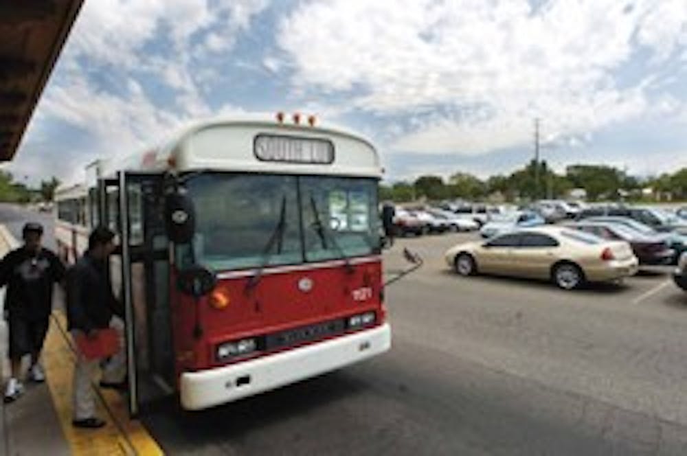 UNM students registered for summer classes board the South Lot shuttle last July. UNM parking officials will close South, Zia and I parking lots in an effort to improve efficiency. 