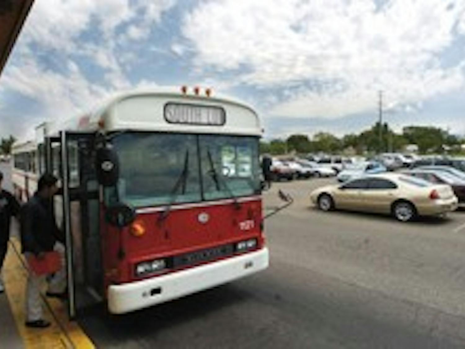 UNM students registered for summer classes board the South Lot shuttle last July. UNM parking officials will close South, Zia and I parking lots in an effort to improve efficiency.