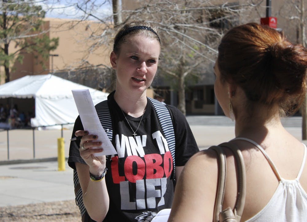 ASUNM presidential candidate Jenna Hagengruber speaks to a student outside Zimmerman Plaza Tuesday afternoon. ASUNM is gearing up for elections that will take place April 8. 