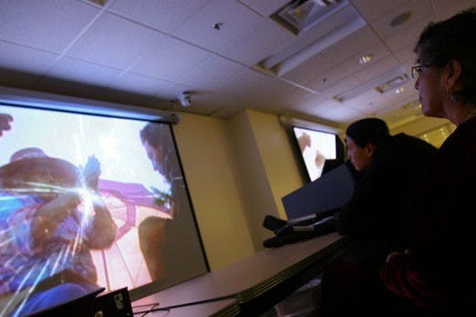 Mary Alice Tsosie and Mario Atencio watch "In the Light of Reverence" during the film festival in honor of Indigenous Day on Monday in Zimmerman Library. 