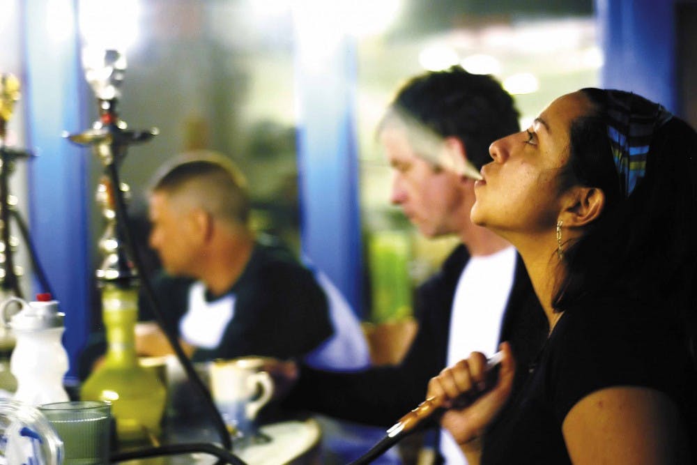 Brenna Wilmsen smokes hookah Monday at Hunab Hookah at 3400 Constitution Ave. N.E.