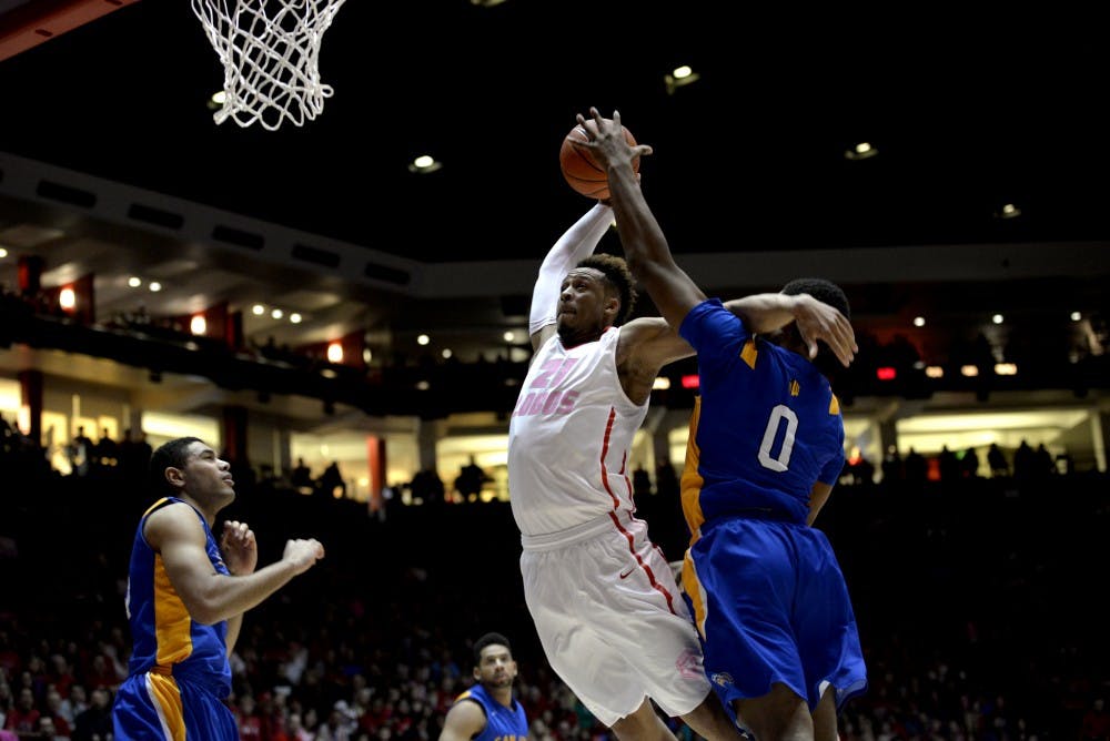 Sophomore guard Xavier Adams leaps to the net past San Jose States Jaycee Hillsman Saturday, Feb. 13, 2016 at WisePies Arena. The Lobos beat San Jose State 74-58. 