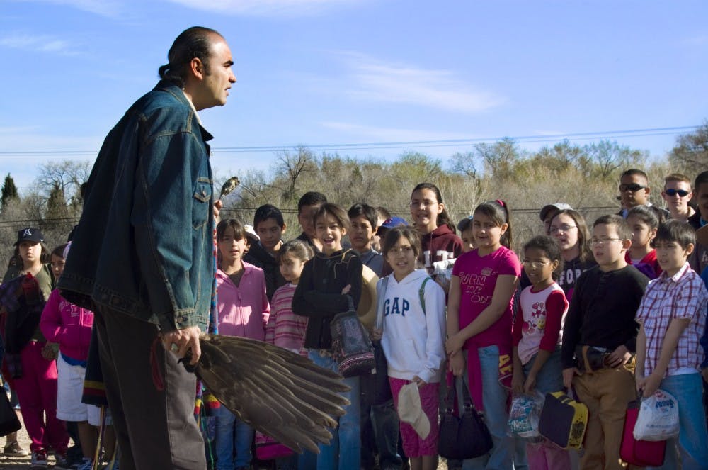 	Albino Garcia, executive director of La Plazita Institute, explains the blessing ceremony he just performed for students from Coronado Elementary School. Garcia blessed the tools and plants used in a community garden at the Sanchez Farm in the South Valley. 