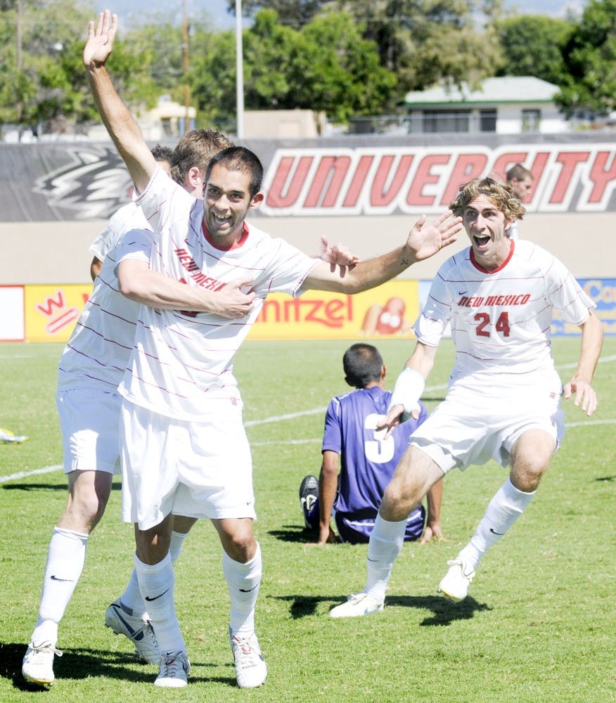 	UNM’s Lawrence Robledo, left, and Josh Caffey, right, celebrate a goal against Portland, despite losing the match, 2-1. The Lobos host Buffalo on Friday and No. 6 Harvard on Sunday at the UNM Soccer Complex.