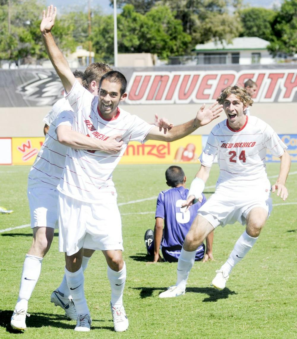 	UNM’s Lawrence Robledo, left, and Josh Caffey, right, celebrate a goal against Portland, despite losing the match, 2-1. The Lobos host Buffalo on Friday and No. 6 Harvard on Sunday at the UNM Soccer Complex.