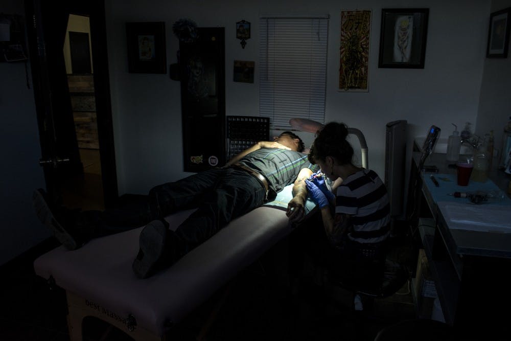 Angelia Santistevan tattoos Louis Cardoza at King’s Kreation Tattoo on Tuesday afternoon. King’s Kreation is one of the tattoo shops participating in this year’s Semicolon Tattoo Project.