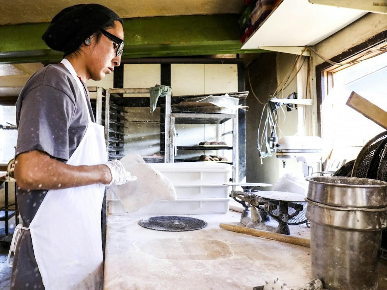 Matt Brown, tosses pizza dough on Sept. 20, 2017 at Golden Crown Panaderia. Golden Crown Panaderia baked loaves of bread and other goods for Hurricane Harvey relief.