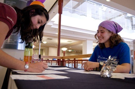 Laura Eberhardt, right, helps Lauren Franco sign up to skip a meal and donate to the Meal Exchange program in the SUB on Tuesday.  