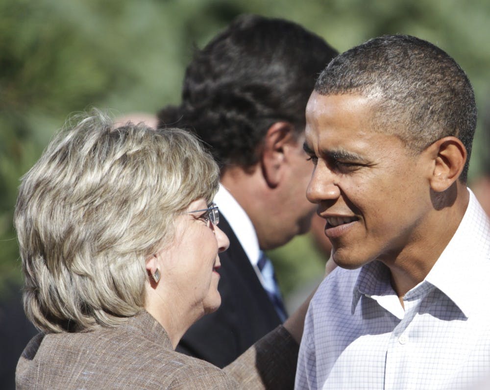 	Obama, right, speaks to gubernatorial candidate Diane Denish after his speech Tuesday in Albuquerque. Denish was among several politicos present at the event