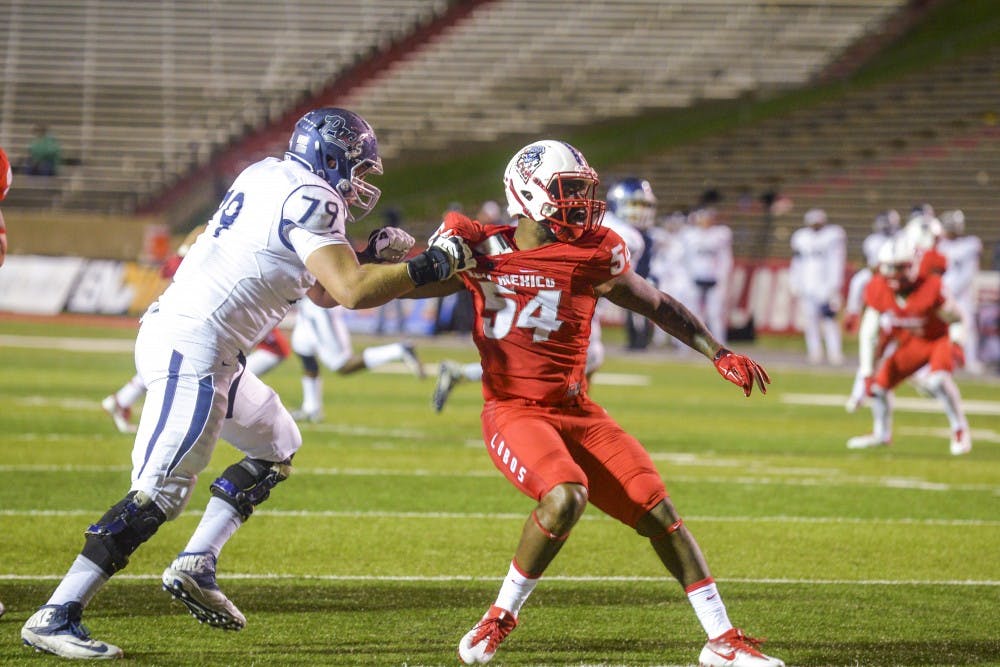 Senior linebacker Donnie White attempts to push off a Nevada University player during their game Saturday, Nov. 5, 2016 at University Stadium. The Lobos had their five-game winning streak cut short by the Colorado State Rams on Saturday with a 49-31 loss.