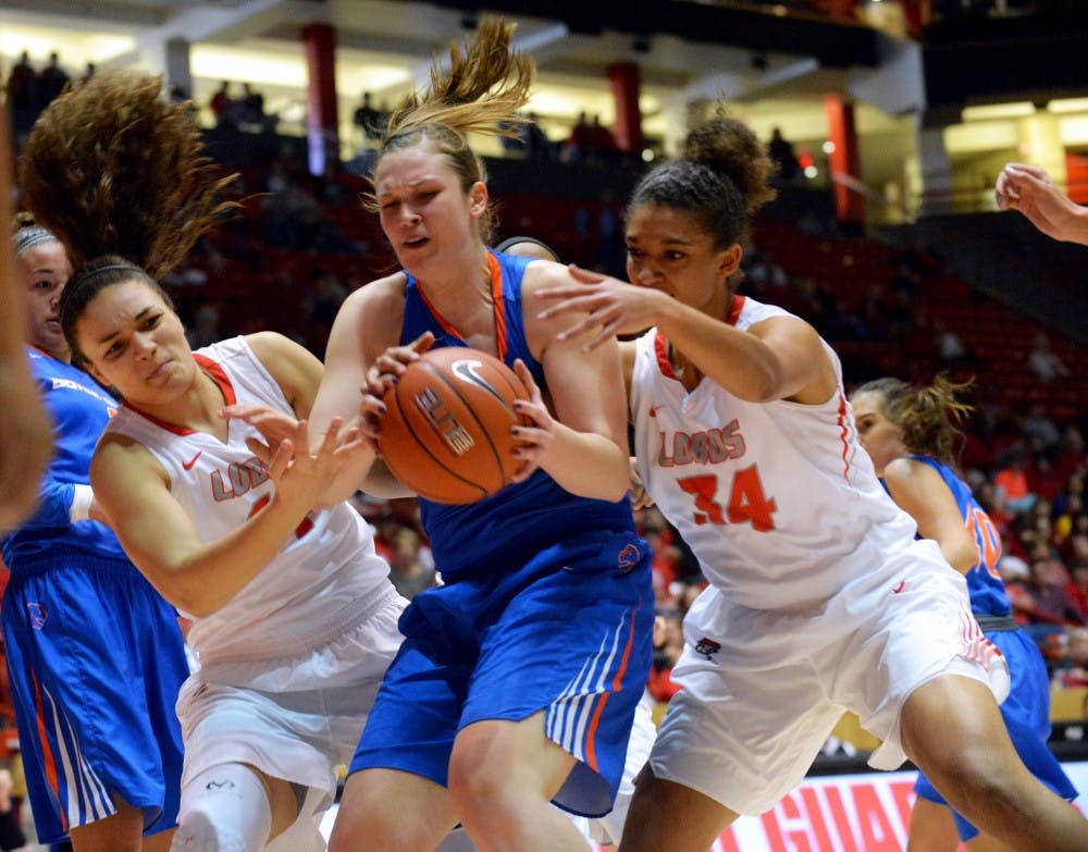 Lobos Jaisa Nunn (left) and Whitney Johnson (right) attempt to guard Boise States Miquelle Askew as she drives to the net Saturday, Jan. 30, 2016 at WisePies Arena. The Lobos lost to Boise State...