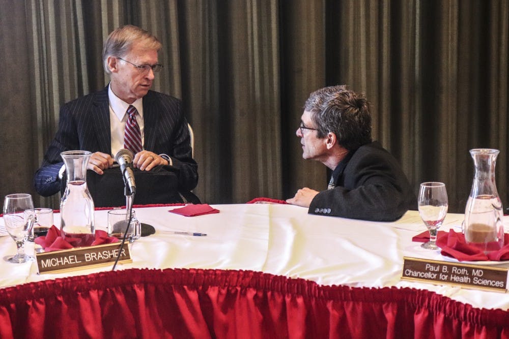 Regent Michael Brasher (left) speaks with interim Provost Richard Wood after Oct. 16, 2018 Board of Regents meeting.
