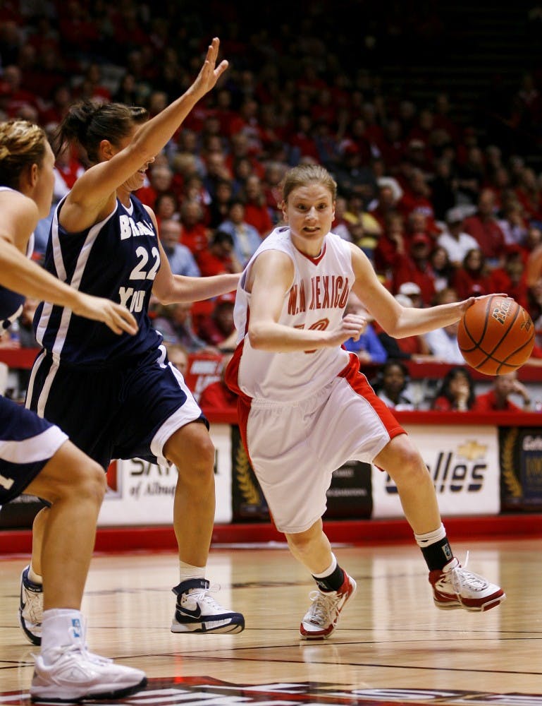 UNM's Amy Beggin dribbles past BYU's Mindy Neilson during their game Saturday at The Pit. The Lobo's lost 38-41.