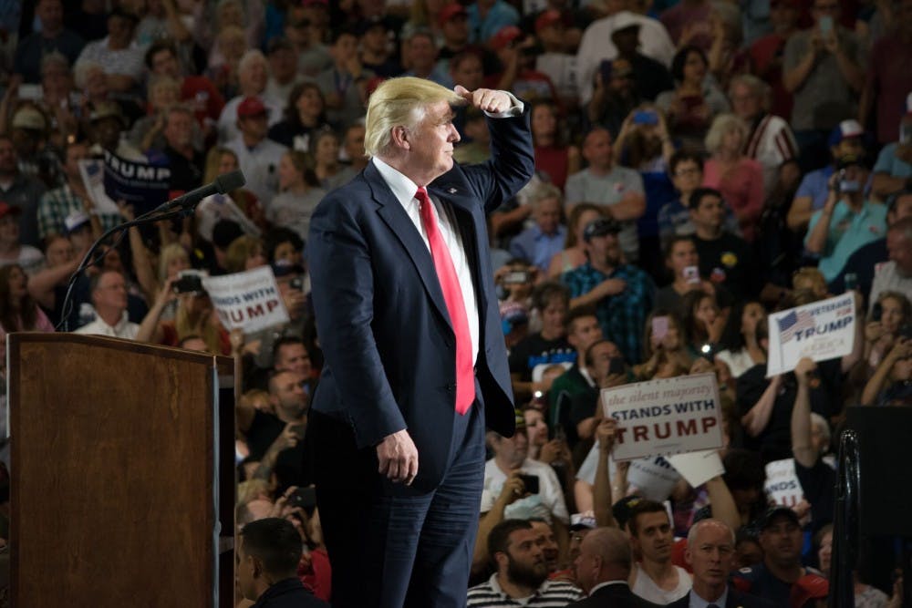 Presidential hopeful Donald Trump spots a protestor during Tuesday nights rally. The night concluded with riots outside of the convention center, trapping supporters inside until other exits were established.