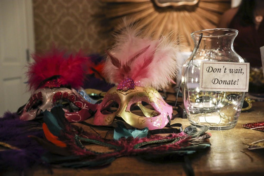 Masquerade masks lay on a table with a donation jar on Saturday evening at Casa Esencia in Old Town. Proceeds benefited One Hope Centro de Vida Health Center and Albuquerque Opportunity Center Clinic.