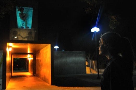 Kira Hirschfeld oversees the first event of "Operation: Center of the Universe" on Thursday. Hirschfeld projected photos onto the sculpture to commemorate the Sept. 11 attacks. 