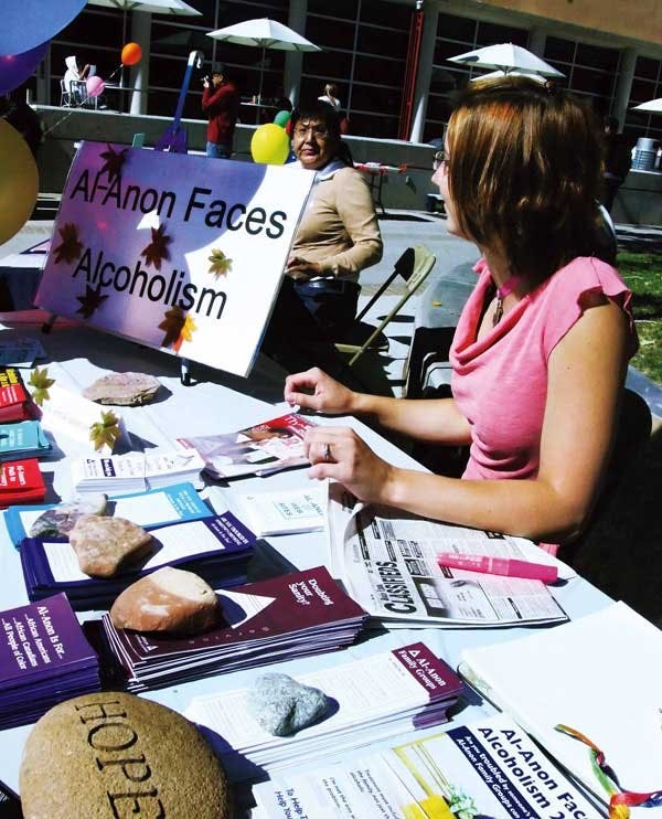 Stephanie Rasinski of Alcoholics Anonymous, left, talks to Beverly Fransico-James during Red Ribbon Day outside the SUB. 