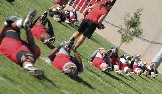 The UNM football team stretches at practice to prepare for Saturday's Homecoming game against Wyoming. UNM lost to the Cowboys 14-10 at Homecoming 2006. 