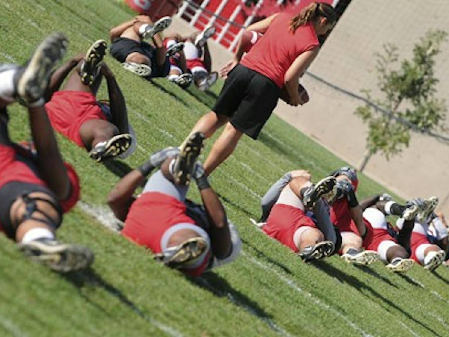 The UNM football team stretches at practice to prepare for Saturday's Homecoming game against Wyoming. UNM lost to the Cowboys 14-10 at Homecoming 2006.