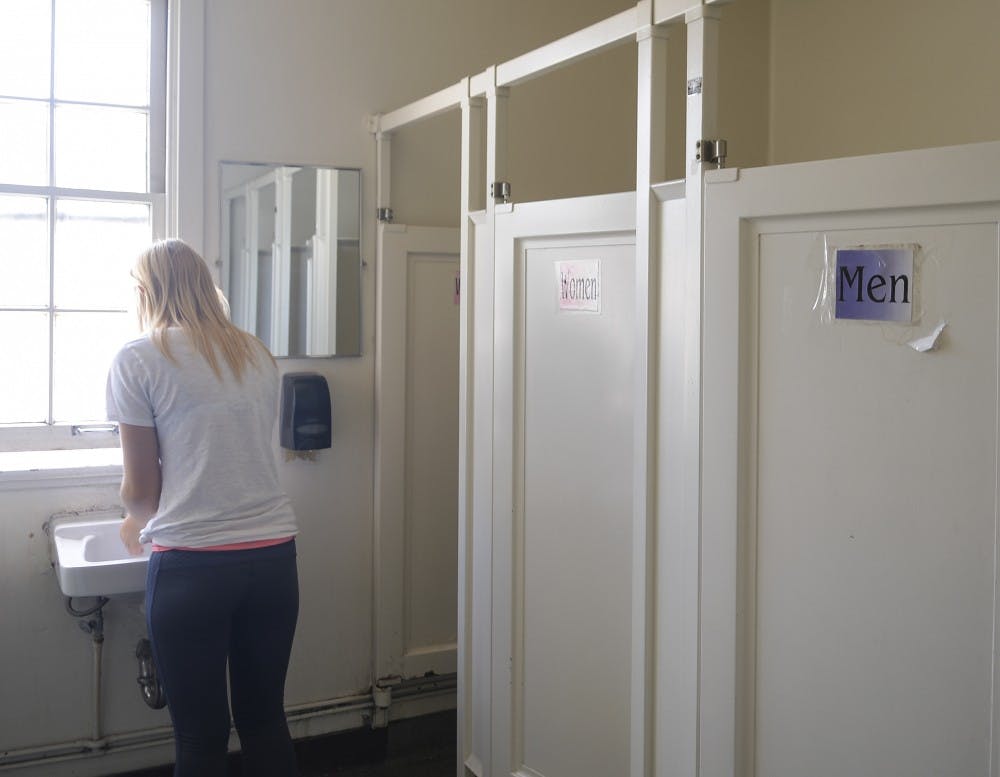 A UNM student washes her hands in a gender-neutral bathroom at Marron Hall on Thursday afternoon. UNM currently has 11 universal bathrooms located on campus.