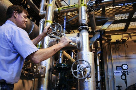 Dan Hewes, master utility plant technician, adjusts energy levels in the cogeneration unit at Ford Utility Center on Sunday.