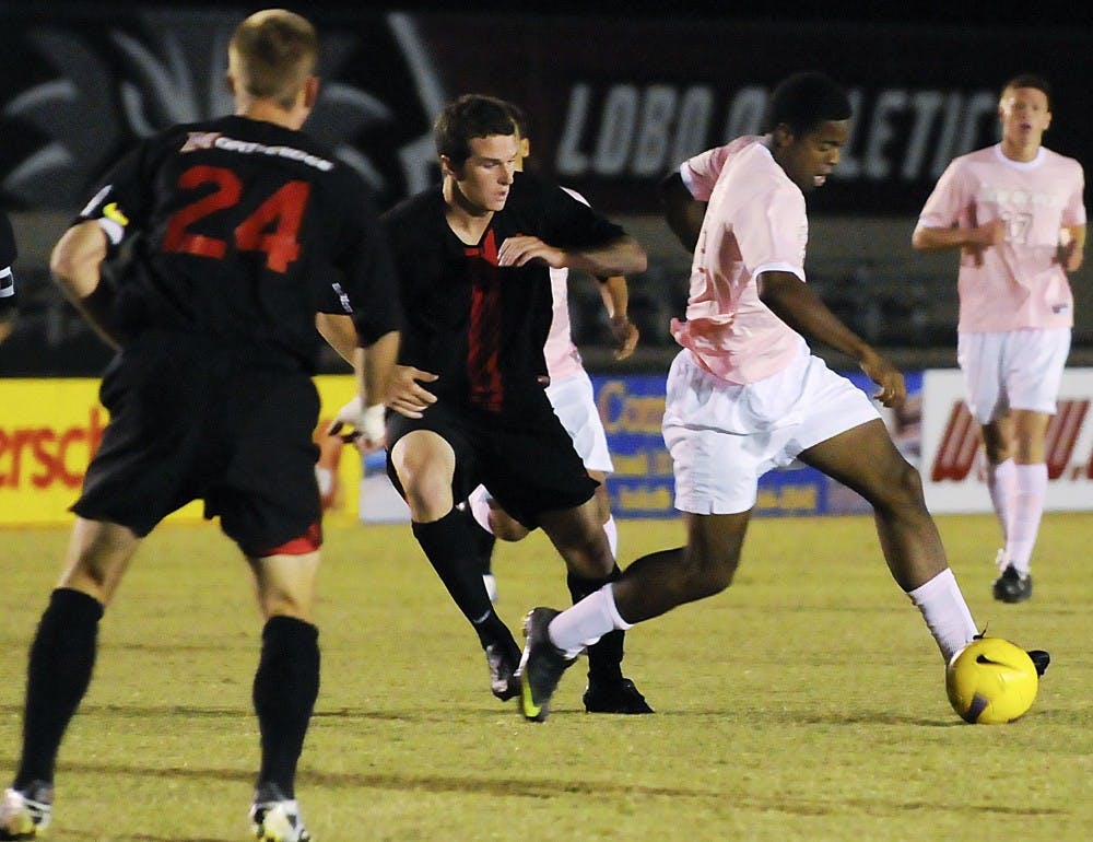 	Michael Green fends off a Cal State defender during Saturday’s game at the UNM Soccer Complex. Green had two goals in the Lobos’ 2-0 win.