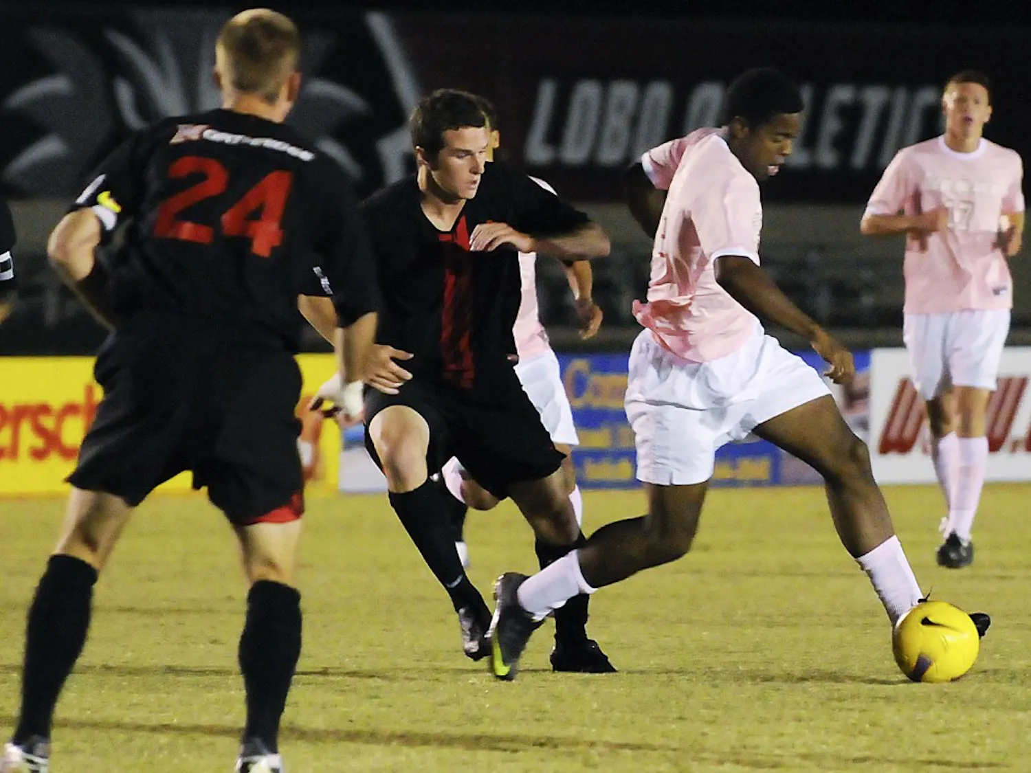 Michael Green fends off a Cal State defender during Saturday’s game at the UNM Soccer Complex. Green had two goals in the Lobos’ 2-0 win.