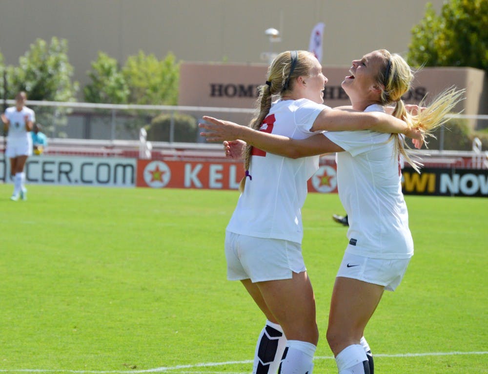 UNM’s Quincy Slora and Korynn Blanksma celebrate after scoring a goal against Idaho State Thursday at the UNM Soccer Complex. The Lobos beat Idaho State 4-1 for their second win this season.