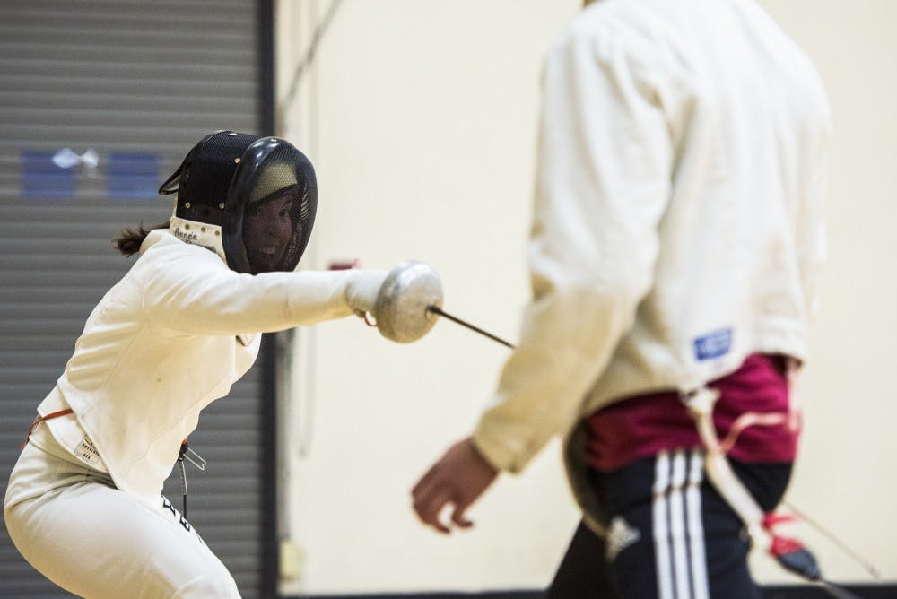 Renee Reeves (left) lunges towards Sonny Christopher Haquani last Thursday night at Johnson Gym. The UNM Fencing Club practices Tuesday and Thursday nights at Johnson Gym. 