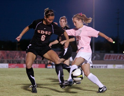 Forward Jennifer Williams, right, fights for the ball on Friday at the UNM Soccer Complex. UNM tied San Diego State 1-1 and is 7-5-5 overall and 2-3-1 in the Mountain West Conference.