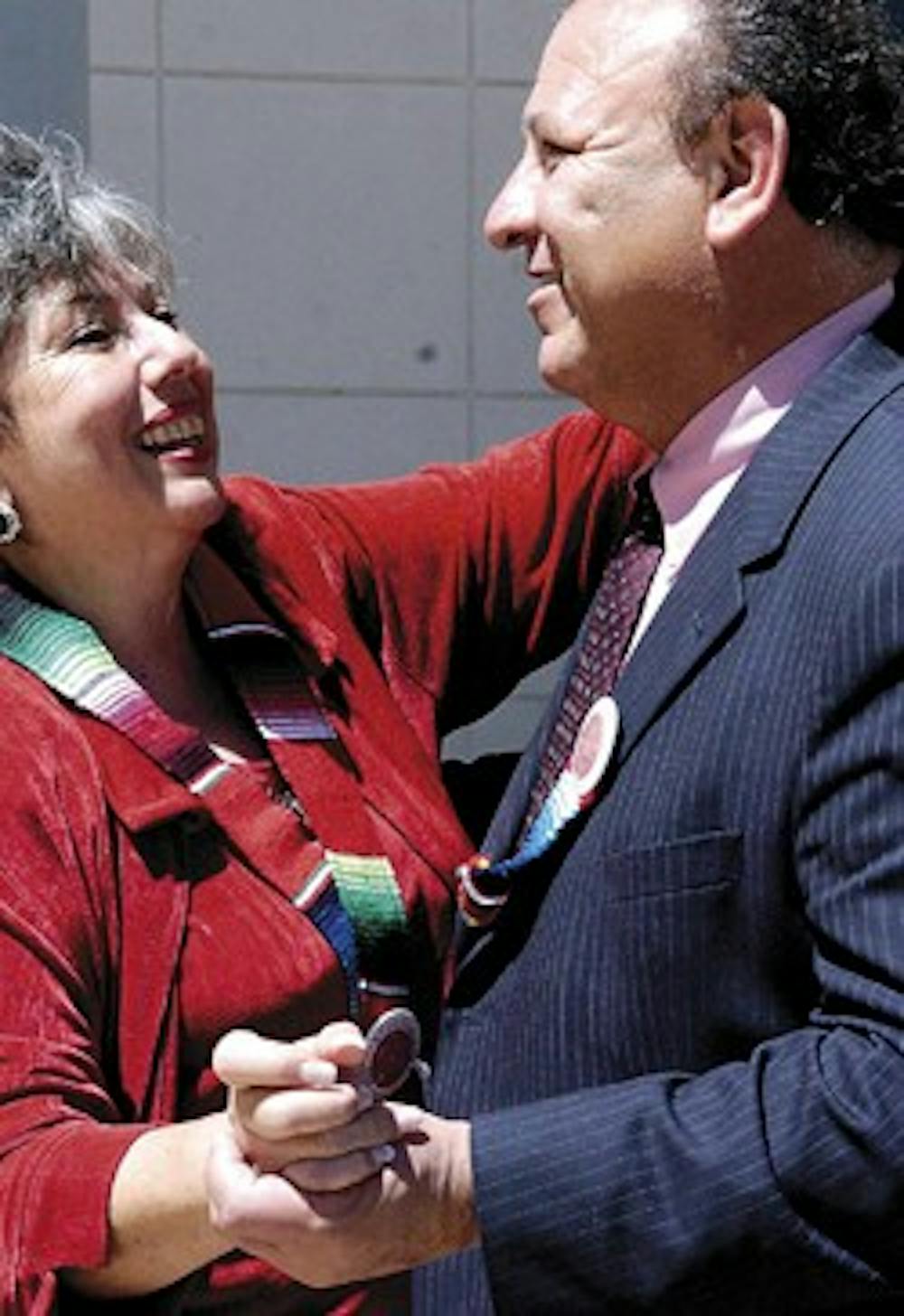 Nieves Torres, left, dances with her husband Eliseo Torres in the Honors Courtyard after she received her master's degree during the El Centro de la Raza graduation ceremony Saturday in the SUB. 