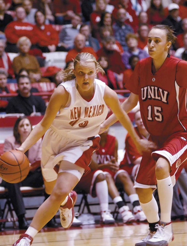 UNM guard Katie Montgomery dribbles around UNLV forward Faye Muller on Saturday at The Pit. The Lobos won 77-56.