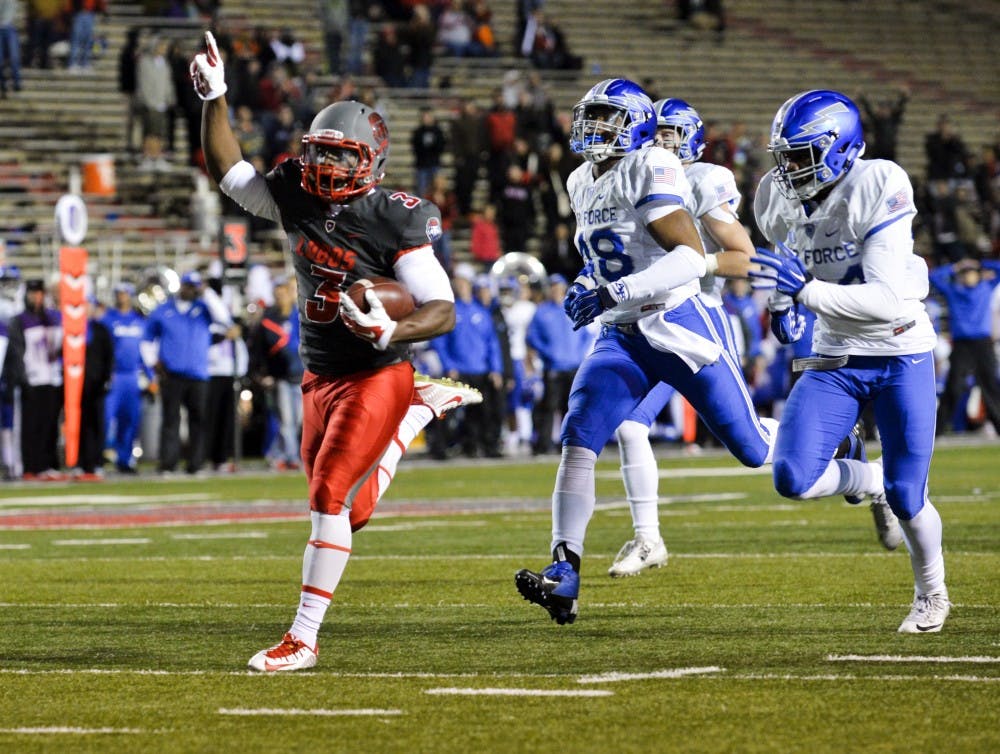 Sophomore running back Richard McQuarley runs into the end zone at University Stadium Saturday night. The Lobos beat Air Force 47-35 in their last season game.&nbsp;