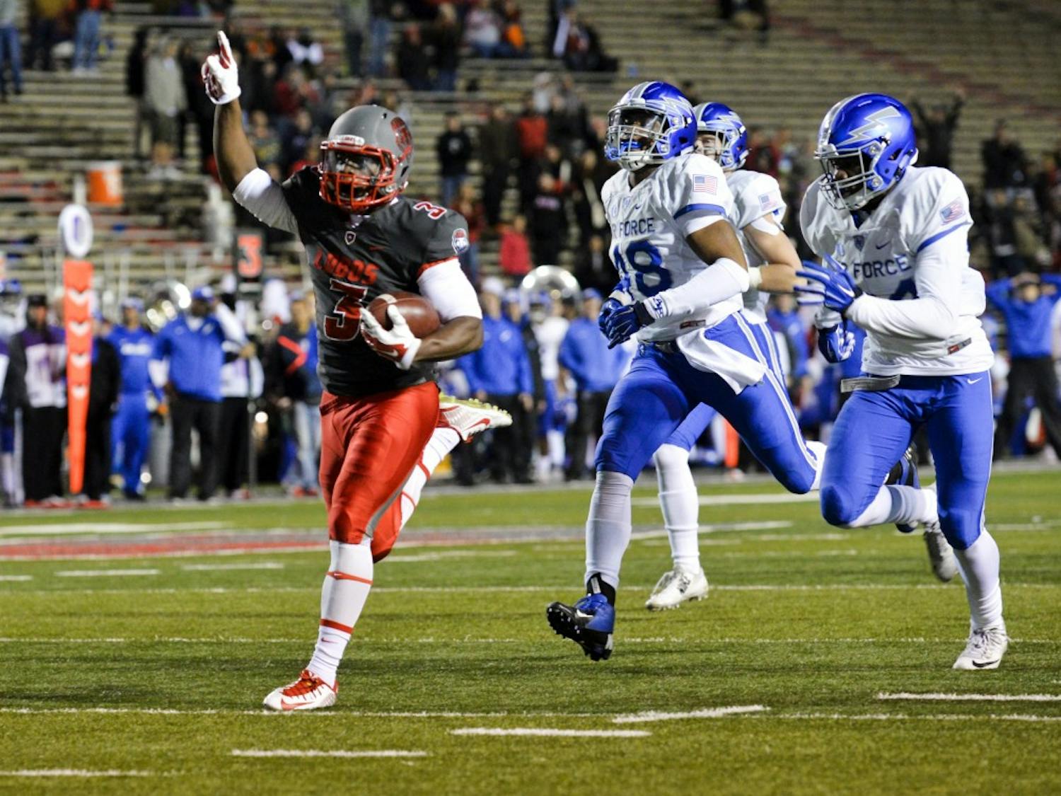 Sophomore running back Richard McQuarley runs into the end zone at University Stadium Saturday night. The Lobos beat Air Force 47-35 in their last season game. 