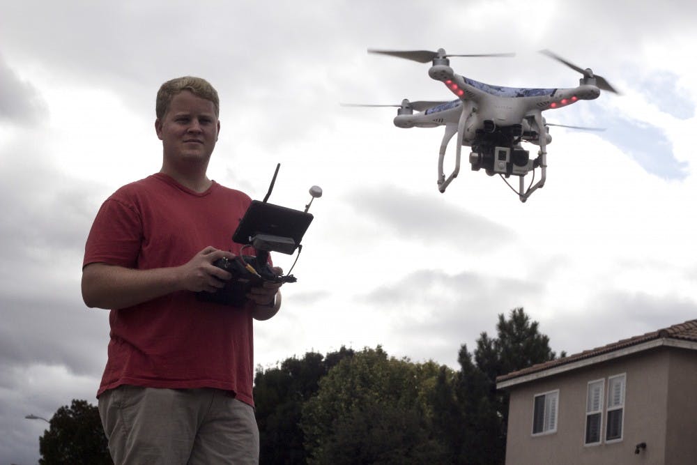 Paul Aitken flies a personal unmanned aerial vehicle, or UAV, around his neighborhood on Monday. Aitken helped create “Legal Flyer,” an application that lets drone pilots obtain flight permission and property releases from a tablet to prevent lawsuits and ensure people in commercial footage are aware they are being recorded.