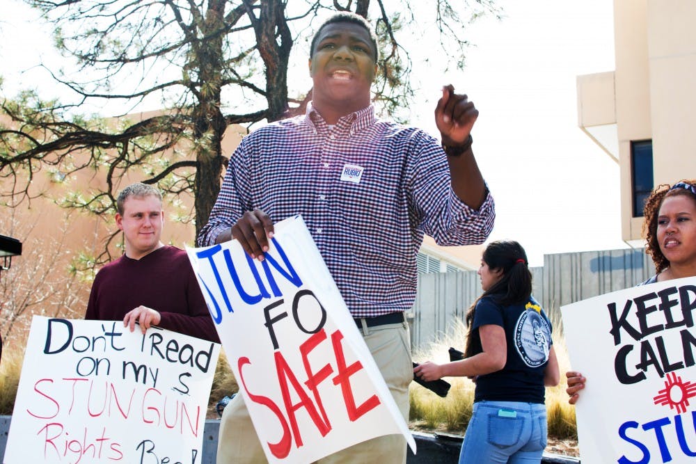 Langston Bowens (center) and other UNM students gathered at Smith Plaza on Monday morning to voice support for allowing stun guns on campus. ASUNM recently voted down a proposal to permit the devices. Bowens said that the proposal is "a matter of security," adding that there are "students on this campus that do not feel safe" and who are "exposed to sexual assault.
