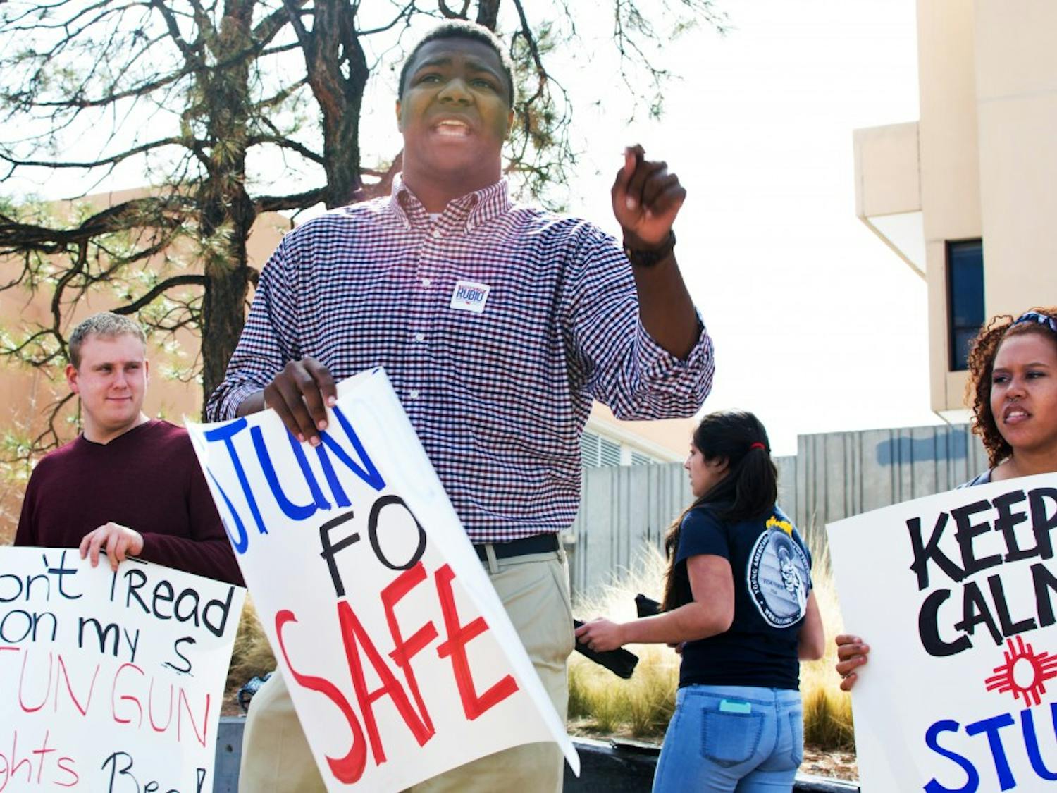 Langston Bowens (center) and other UNM students gathered at Smith Plaza on Monday morning to voice support for allowing stun guns on campus. ASUNM recently voted down a proposal to permit the devices. Bowens said that the proposal is "a matter of security," adding that there are "students on this campus that do not feel safe" and who are "exposed to sexual assault.