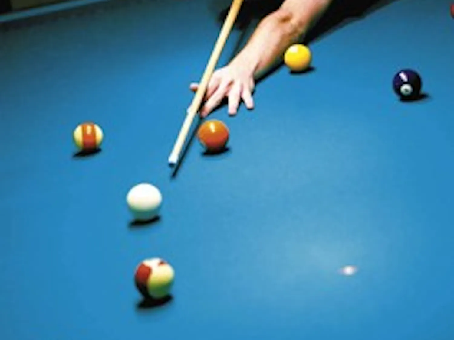 Student Geoffrey Reimann plays billiards in the SUB's game room Tuesday. TechSmith managed the game room from August 2005 to July 2006.