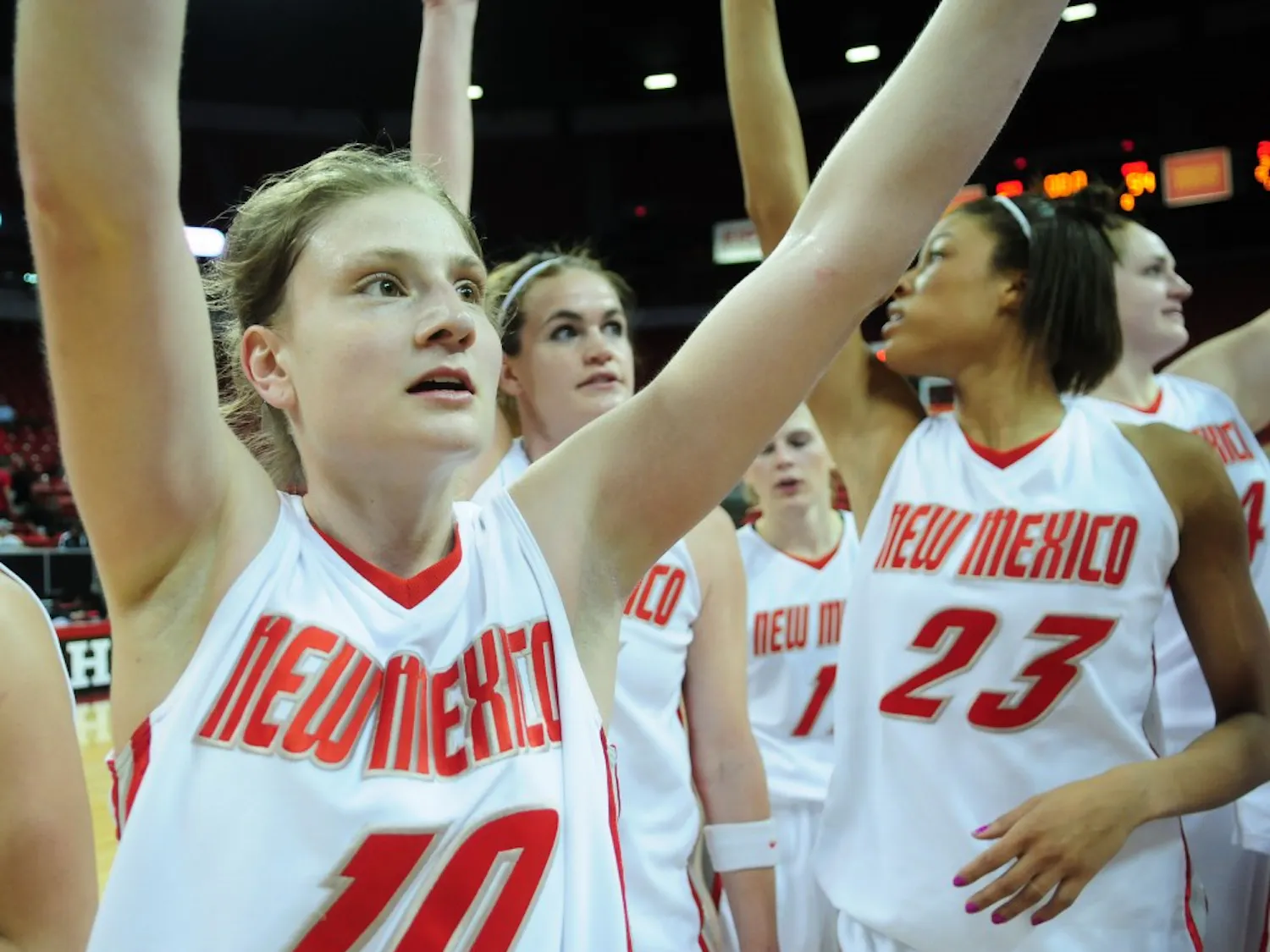Amy Beggin, who finished with 18 points, celebrates with teammates after UNM upended Colorado State 67-54.