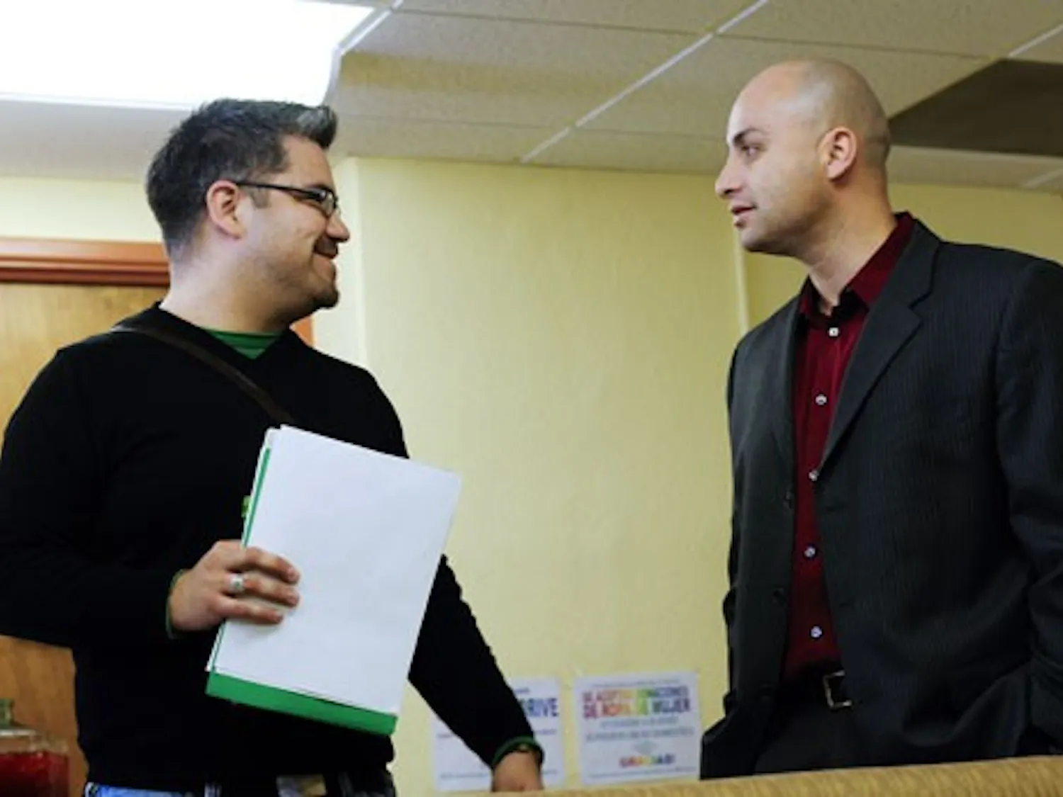 State Auditor Hector Balderas speaks with GPSA President Christopher Ramirez at El Centro de la Raza on Thursday.