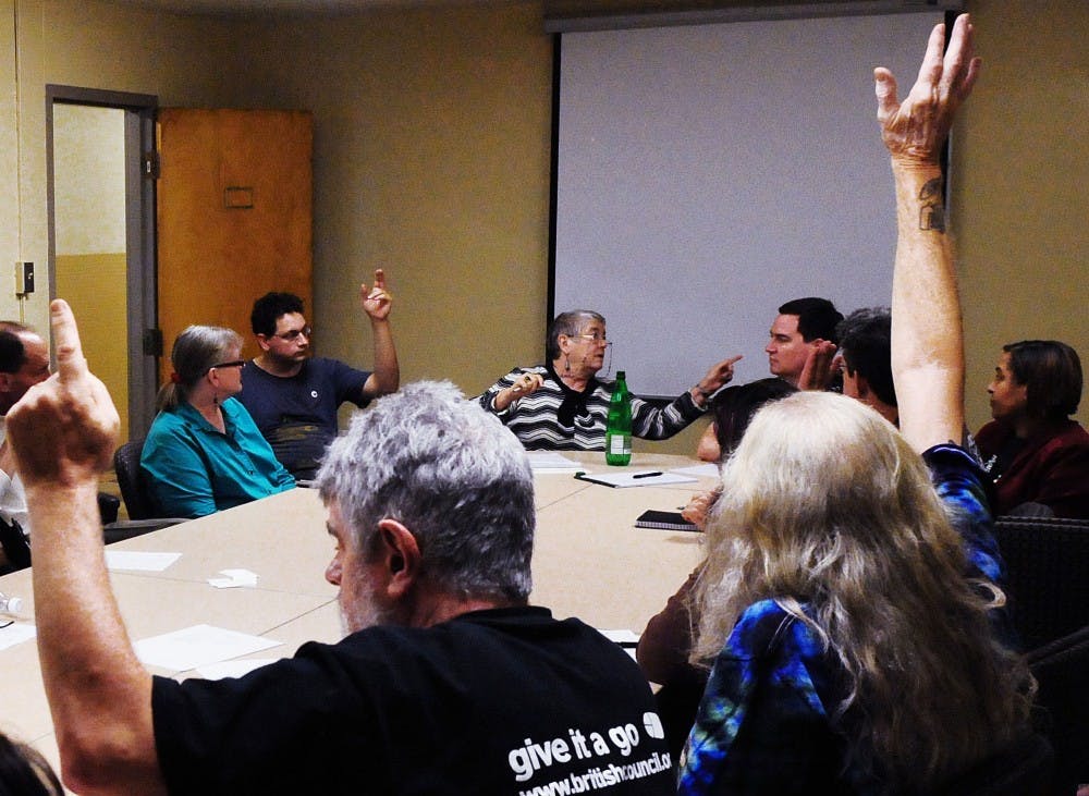 	KUNM volunteers discuss striking a clause from their procedures manual. Many volunteers think the clause, which was added by the University administration, allows the University to not follow their end of the agreement.