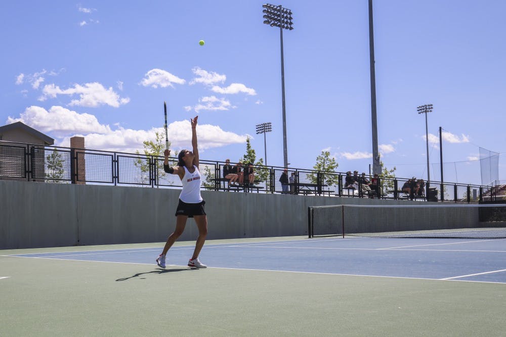 Senior Rachana Bhat focuses towards the sky to serve the ball against a Boise State player Sunday, April 9, 2017 at the McKinnon Family Tennis Stadium.&nbsp;
