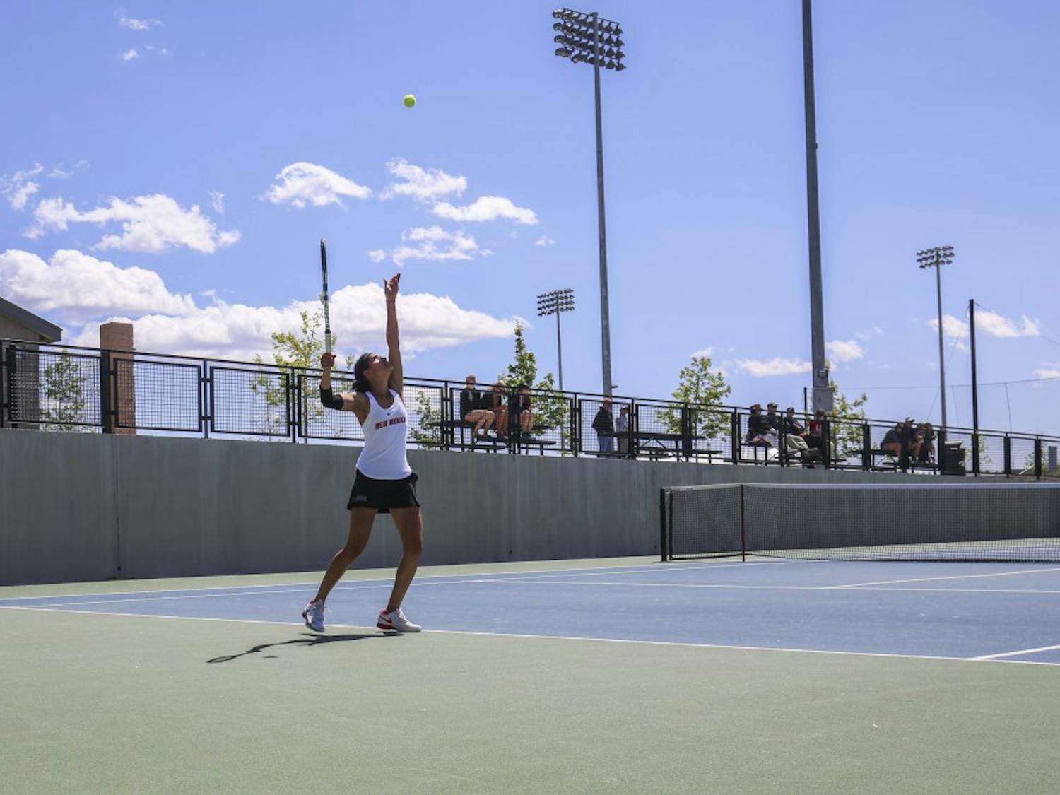 Senior Rachana Bhat focuses towards the sky to serve the ball against a Boise State player Sunday, April 9, 2017 at the McKinnon Family Tennis Stadium. 
