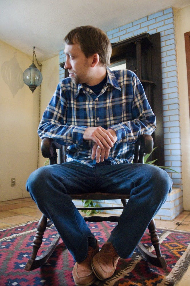 	BillyJoe Miller sits in one of his antique rocking chairs on Thursday in his home. His exhibition, “Tomorrow is Spring” opens on Friday at The Normal Gallery. 
